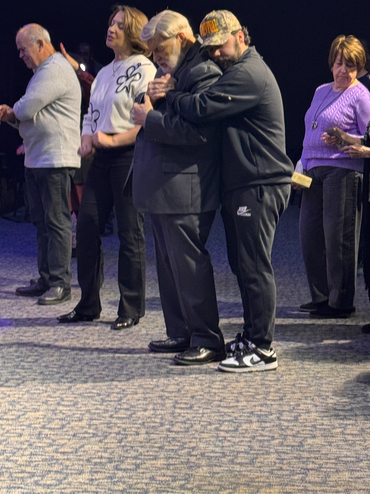 Church members embracing and praying together.