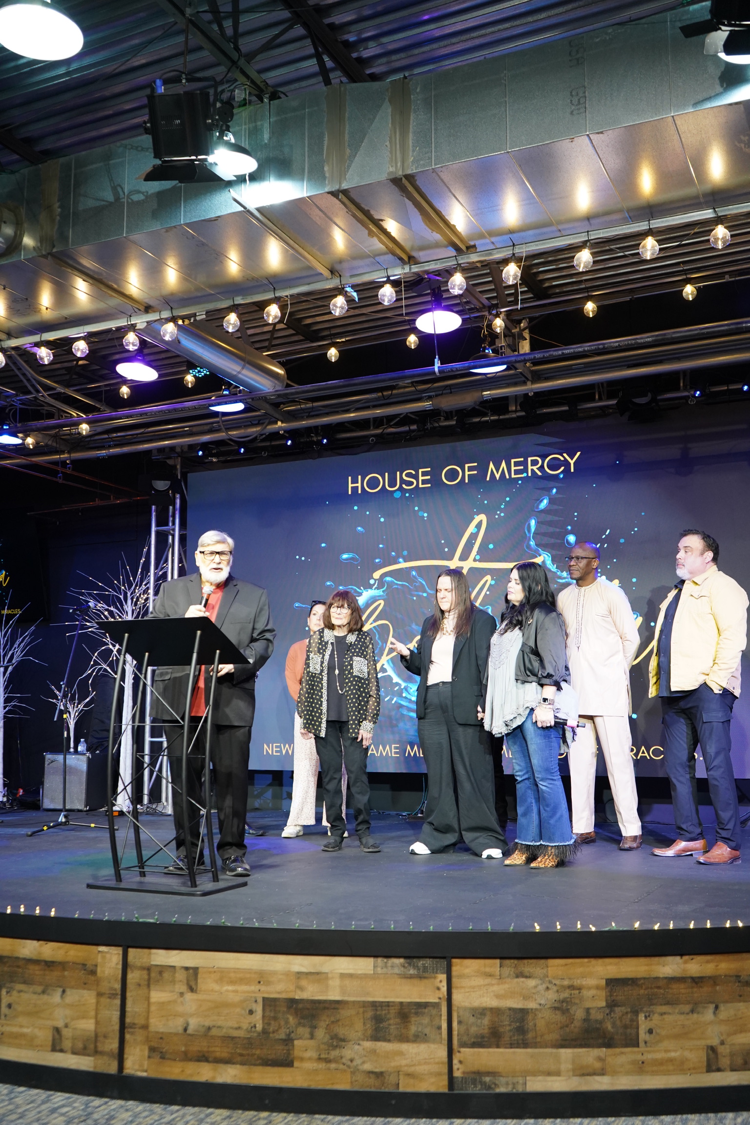 A group gathered together on the church stage.